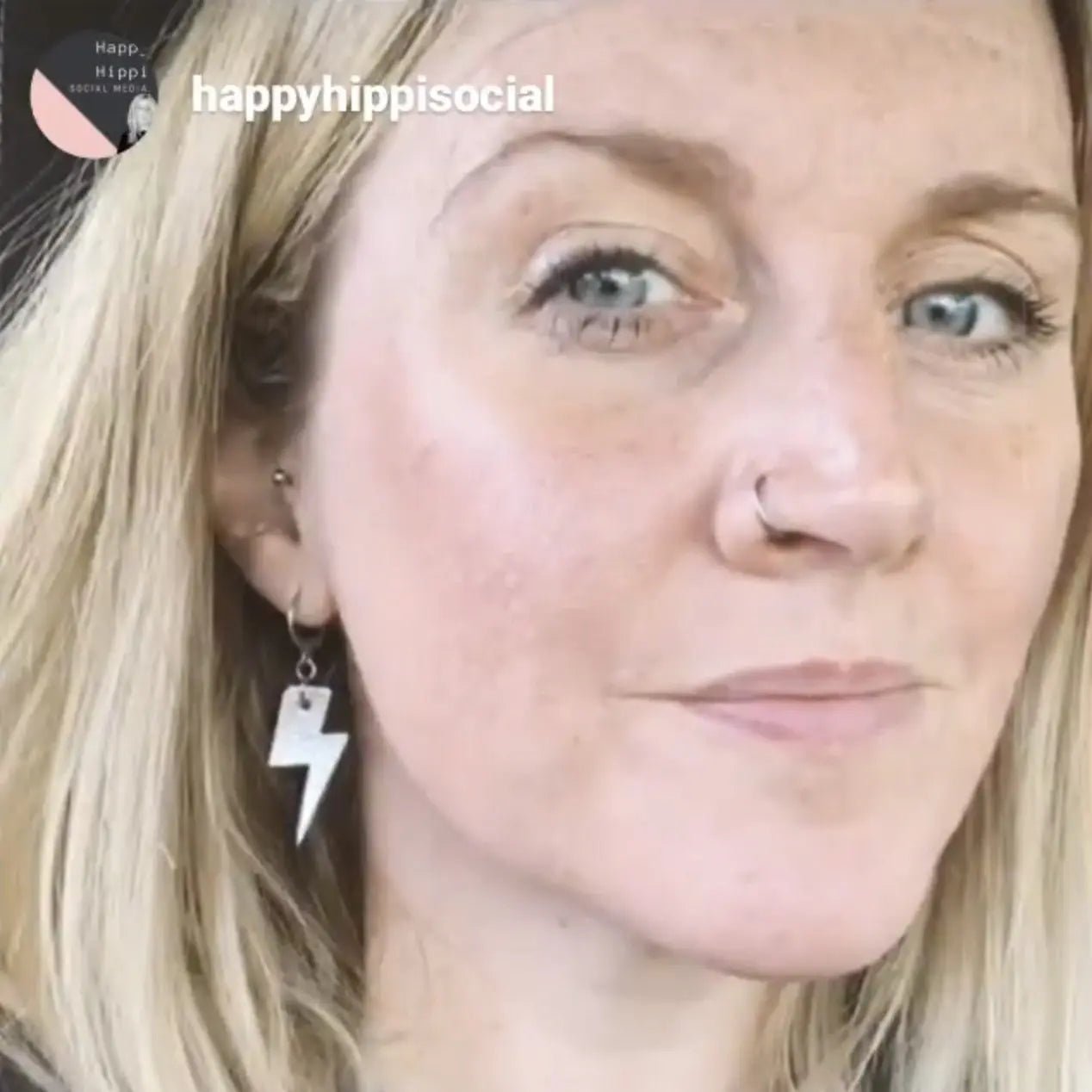 a woman with blonde hair and a nose ring