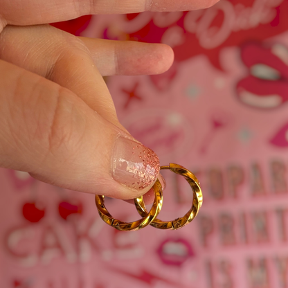 a person holding gold rings