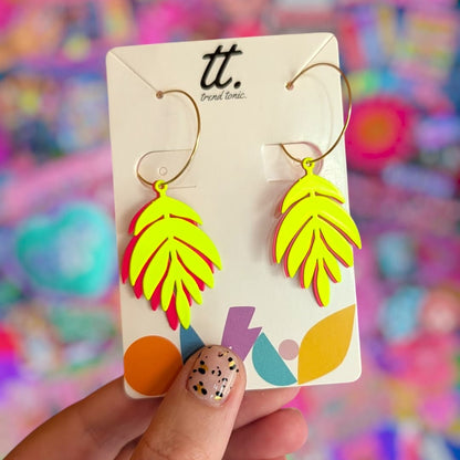 a hand holding a pair of earrings