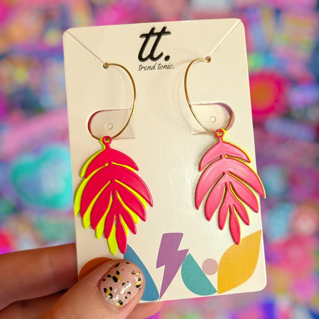 a hand holding a pair of earrings