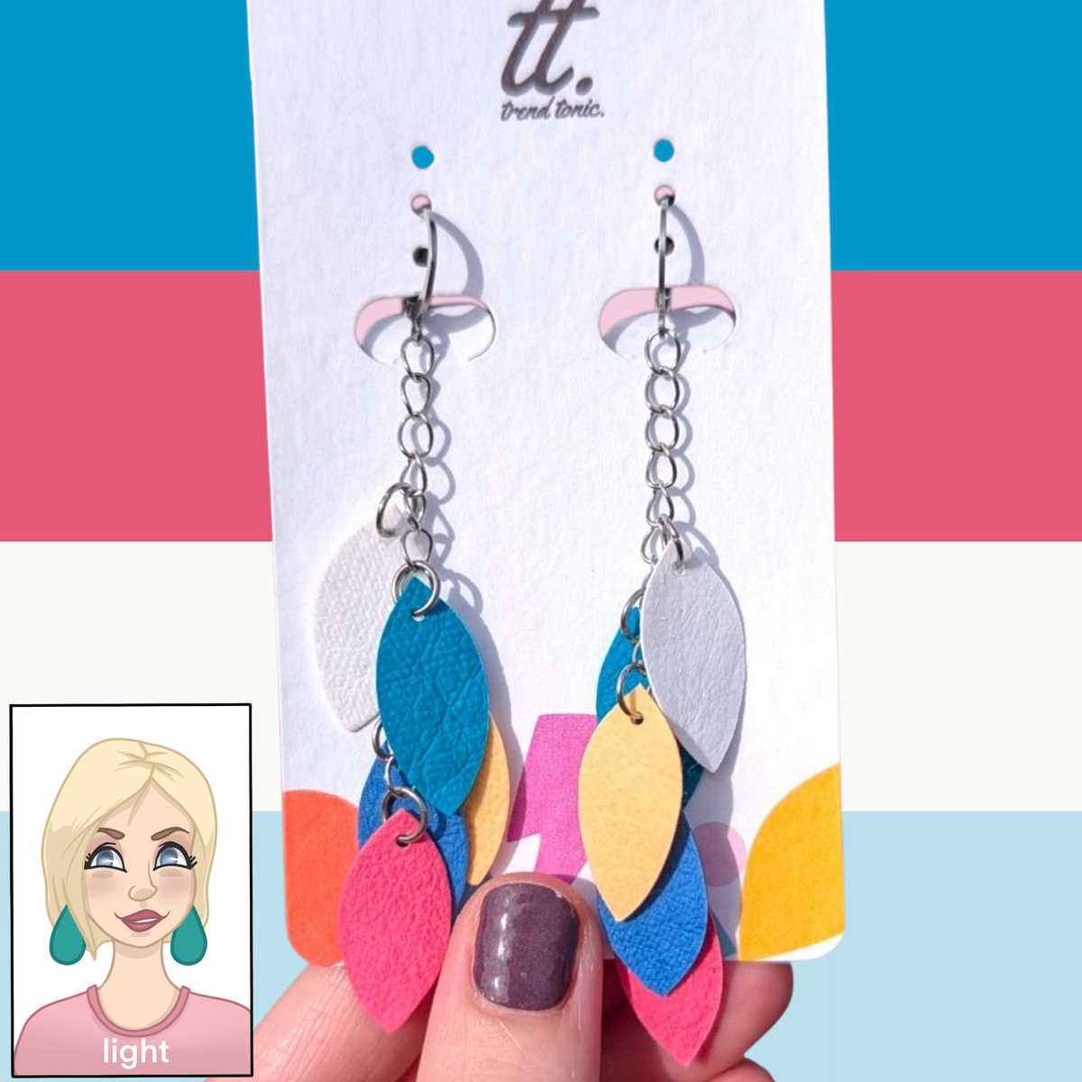 a hand holding a pair of earrings