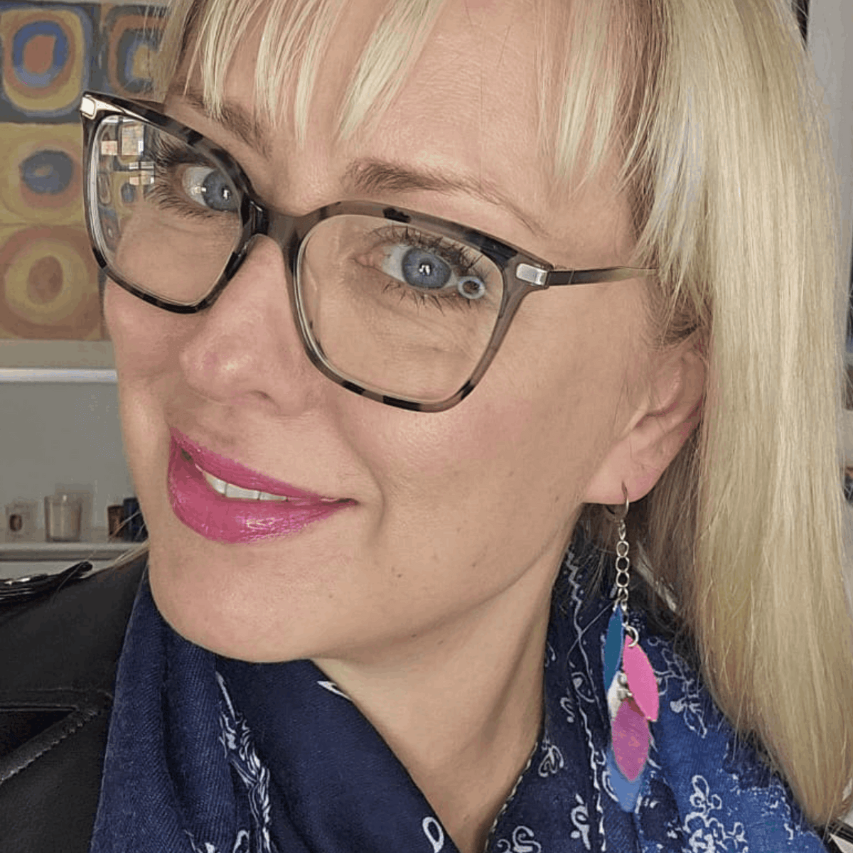 a woman wearing glasses and a scarf