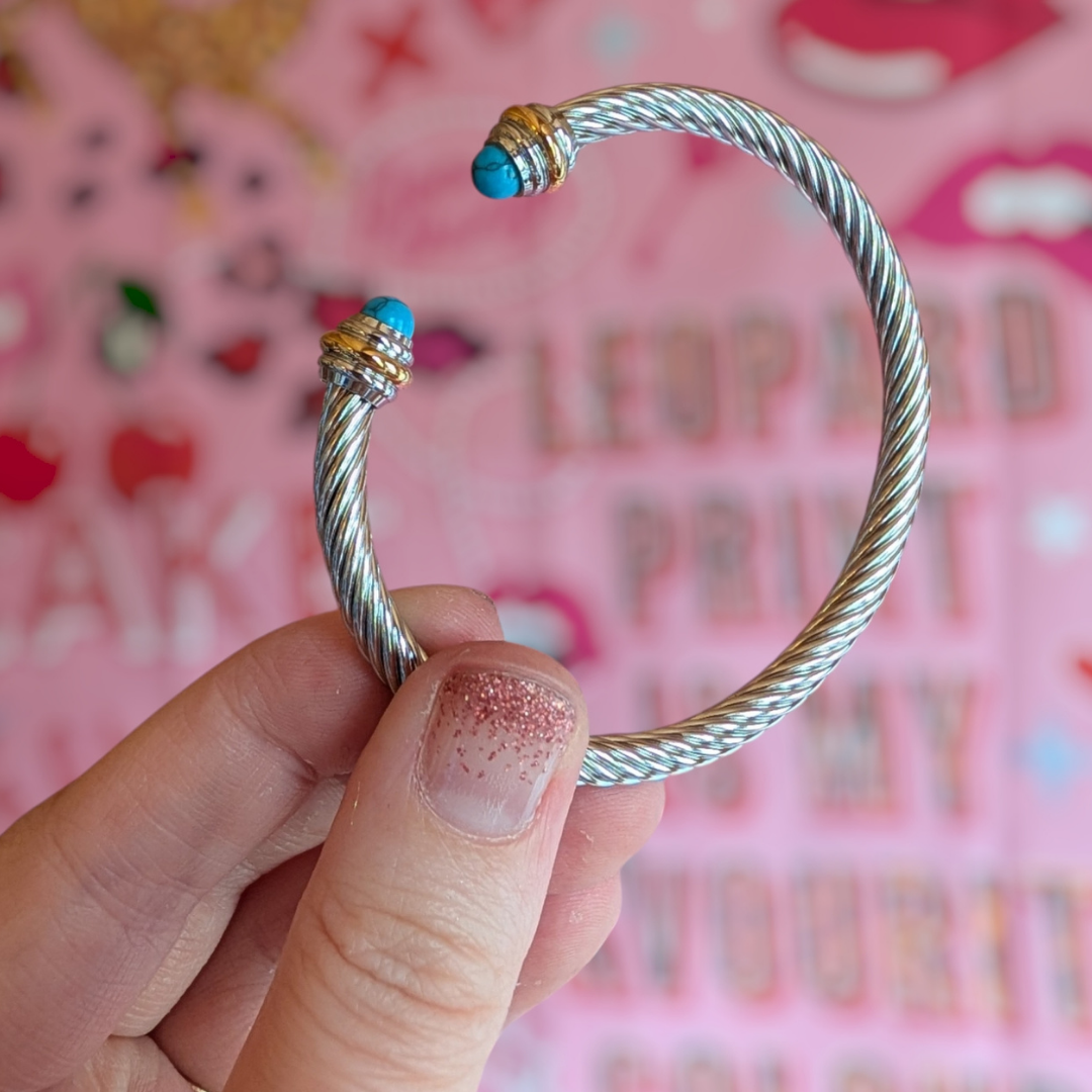 a hand holding a bracelet