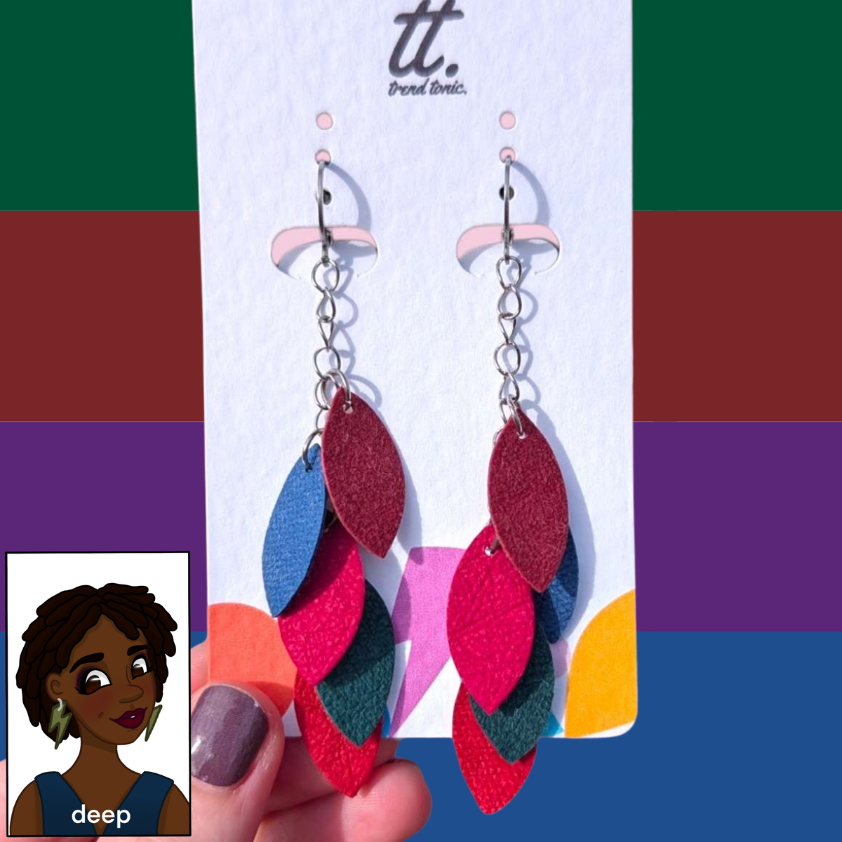 a hand holding a pair of earrings