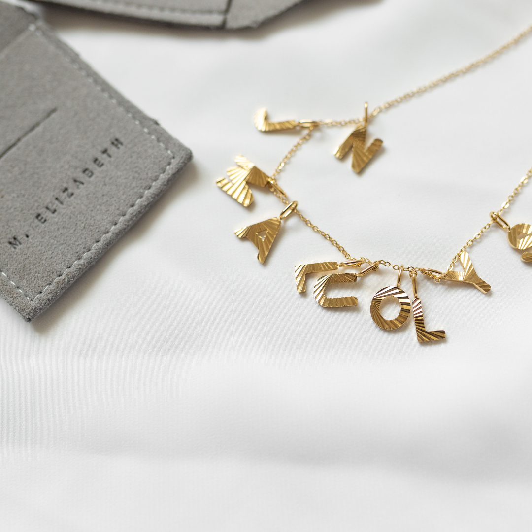 Gold sunbeam initial necklace