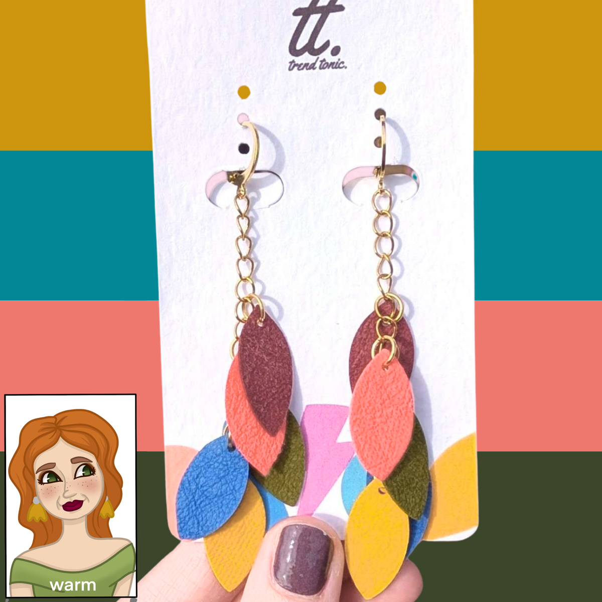 a hand holding a pair of earrings