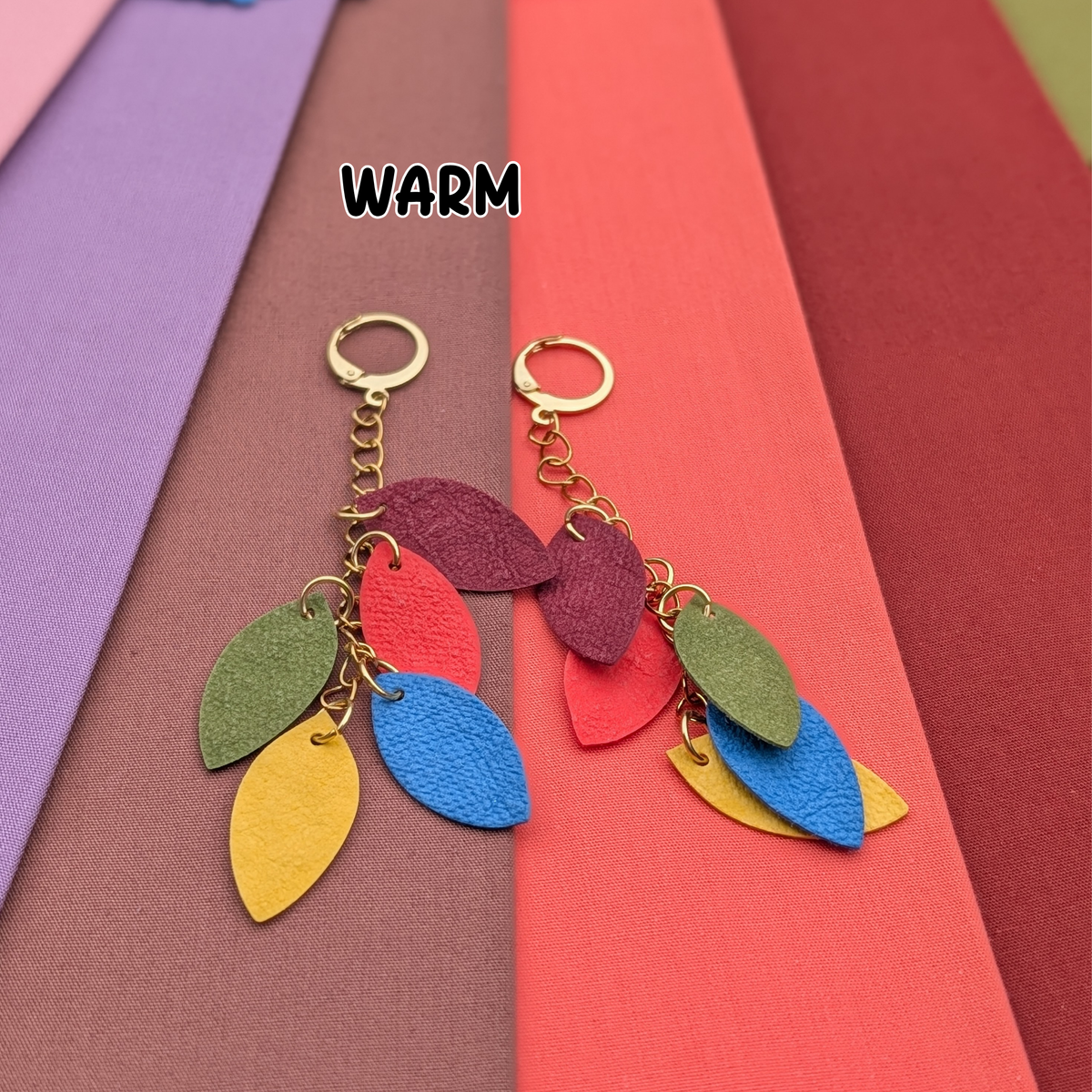 a group of colorful paper with a leaf shaped earrings
