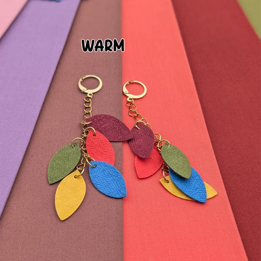 a group of colorful paper with a leaf shaped earrings
