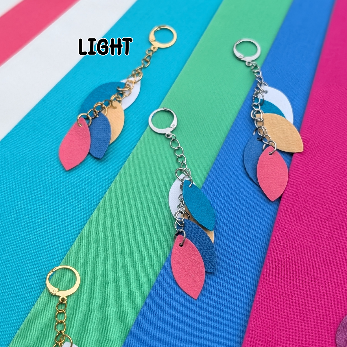 a group of colorful fabric strips with leather keychains