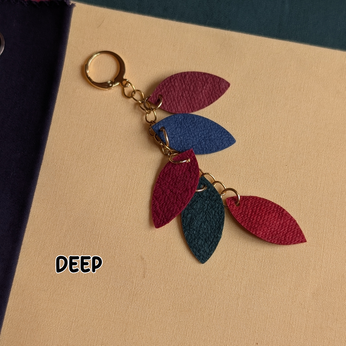 a key chain with leather leaves on it