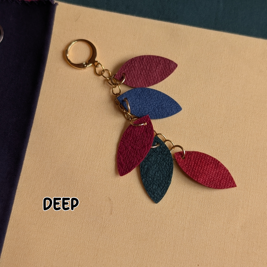 a key chain with leather leaves on it