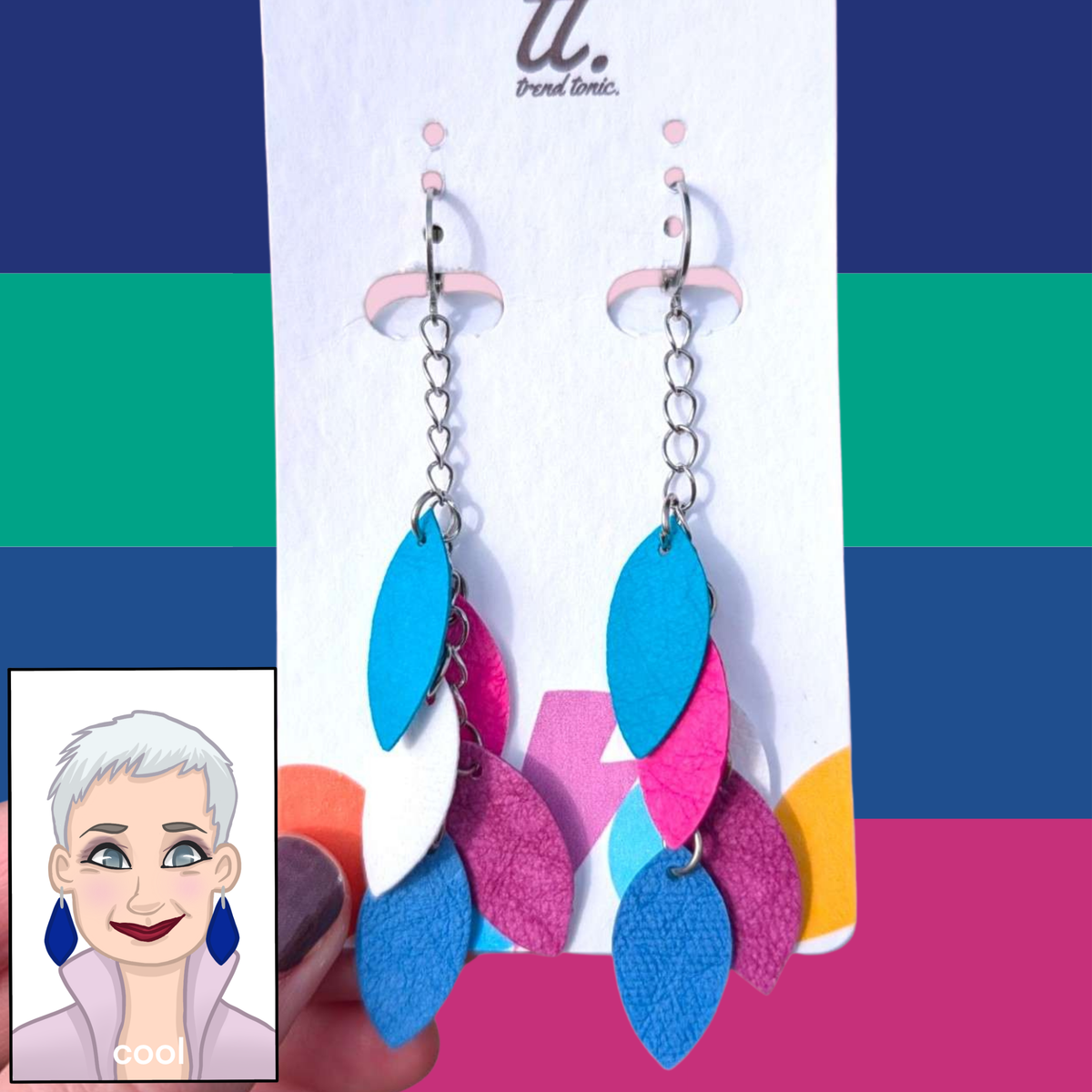 a hand holding a pair of earrings