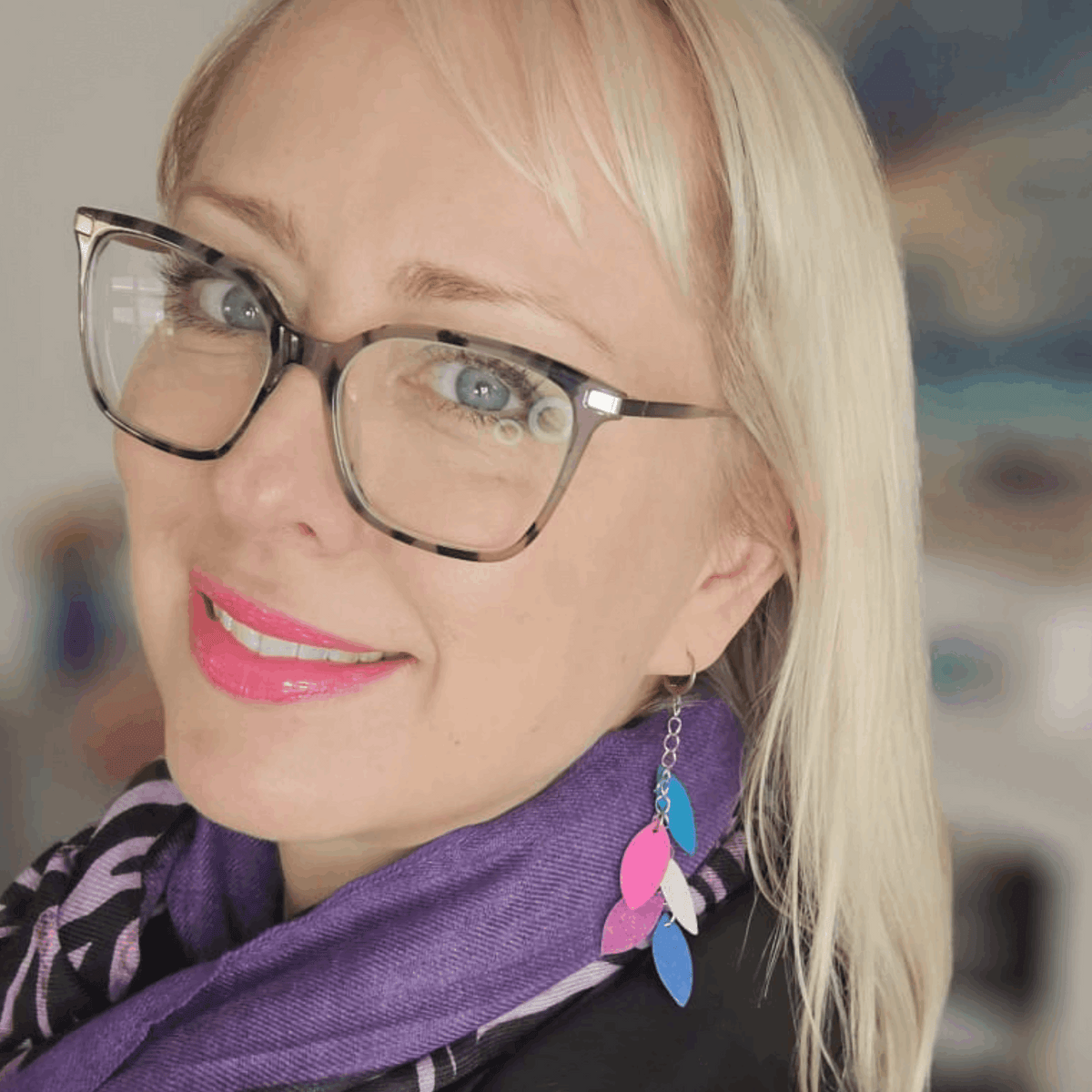 a woman wearing glasses and a scarf