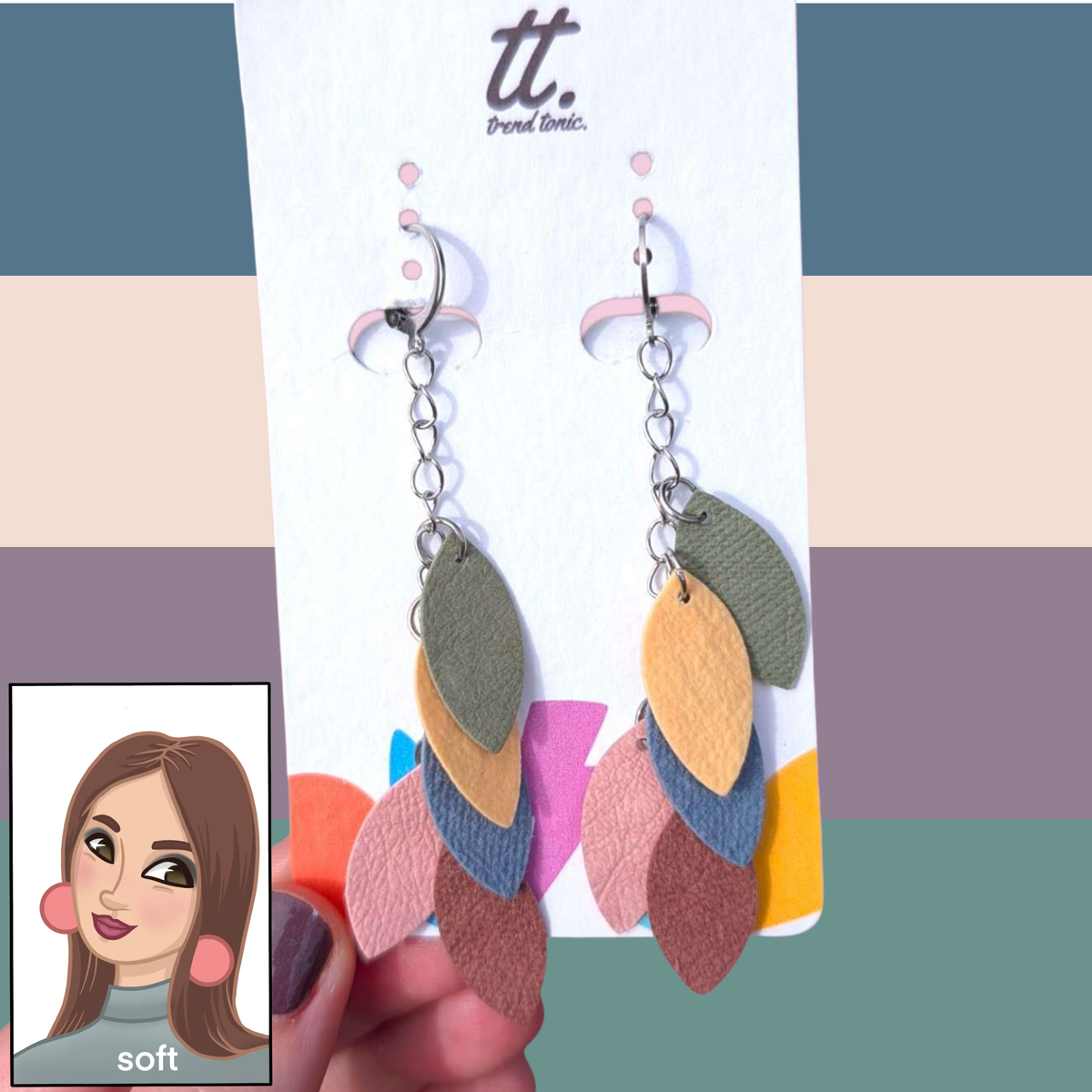 a hand holding a pair of earrings