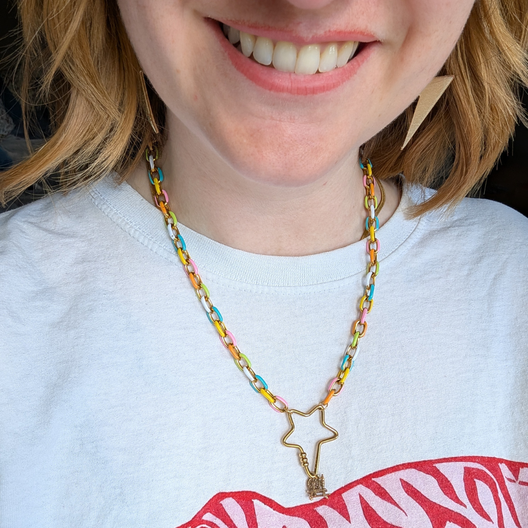 a woman smiling with a necklace