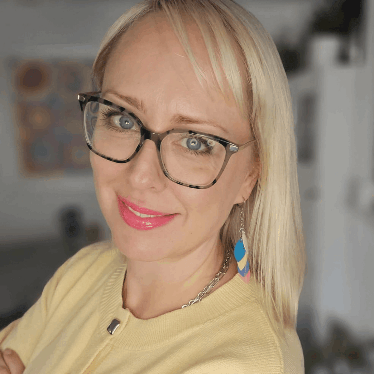 a woman wearing glasses and a yellow sweater