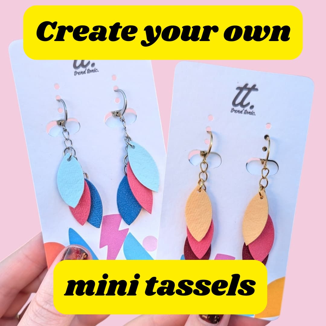 a hand holding a pair of earrings
