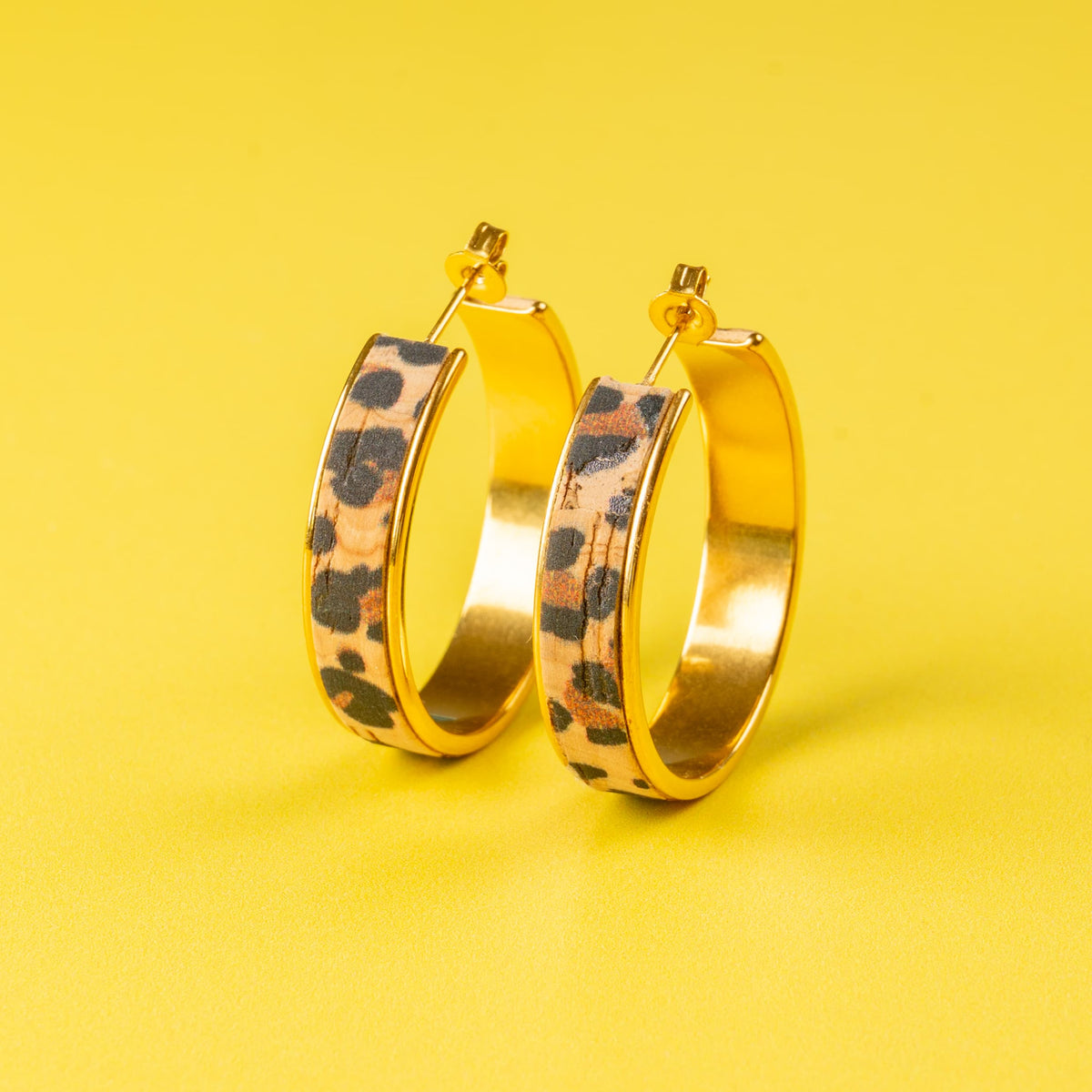 a pair of gold hoop earrings