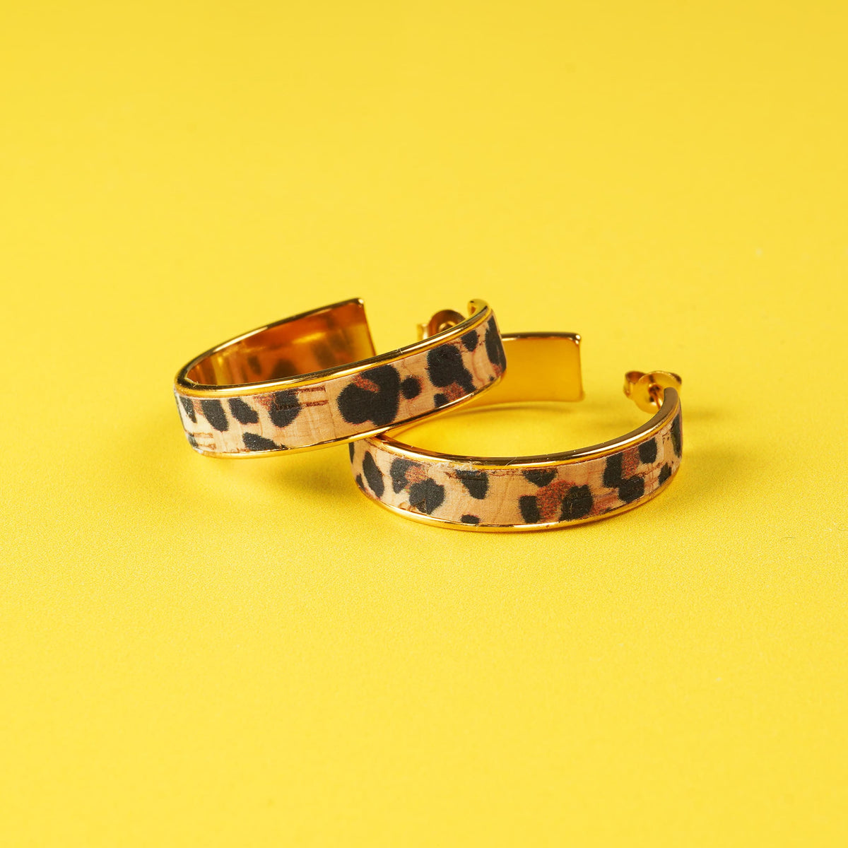 a pair of leopard print earrings