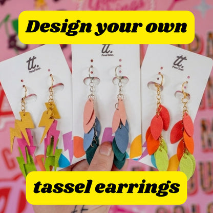 a hand holding a group of earrings