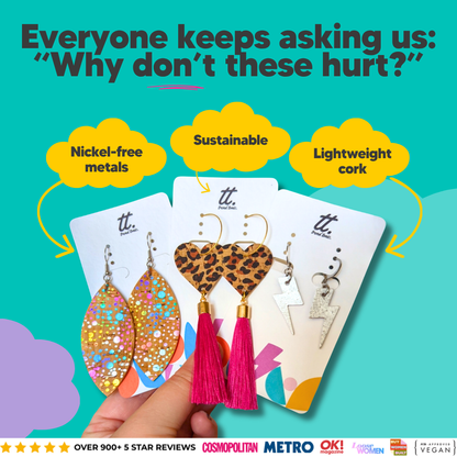 a hand holding a group of earrings