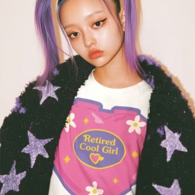 a girl with purple hair and a black coat with stars