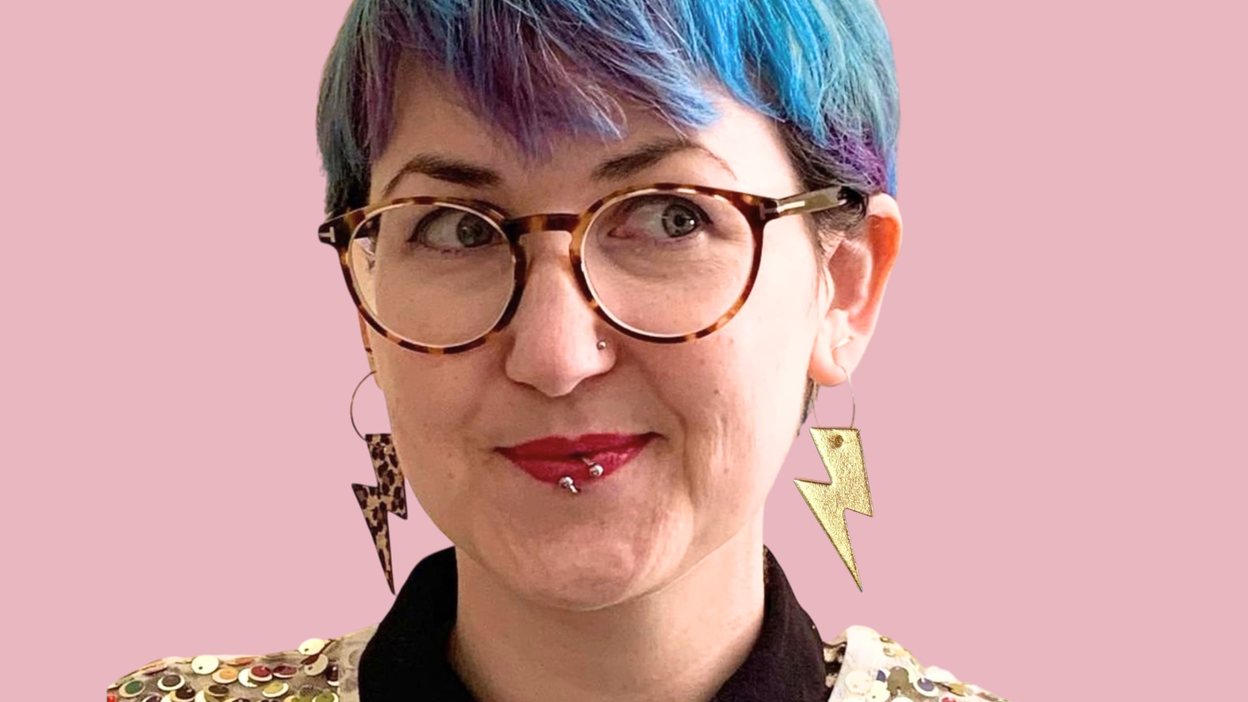 a woman with blue hair and glasses