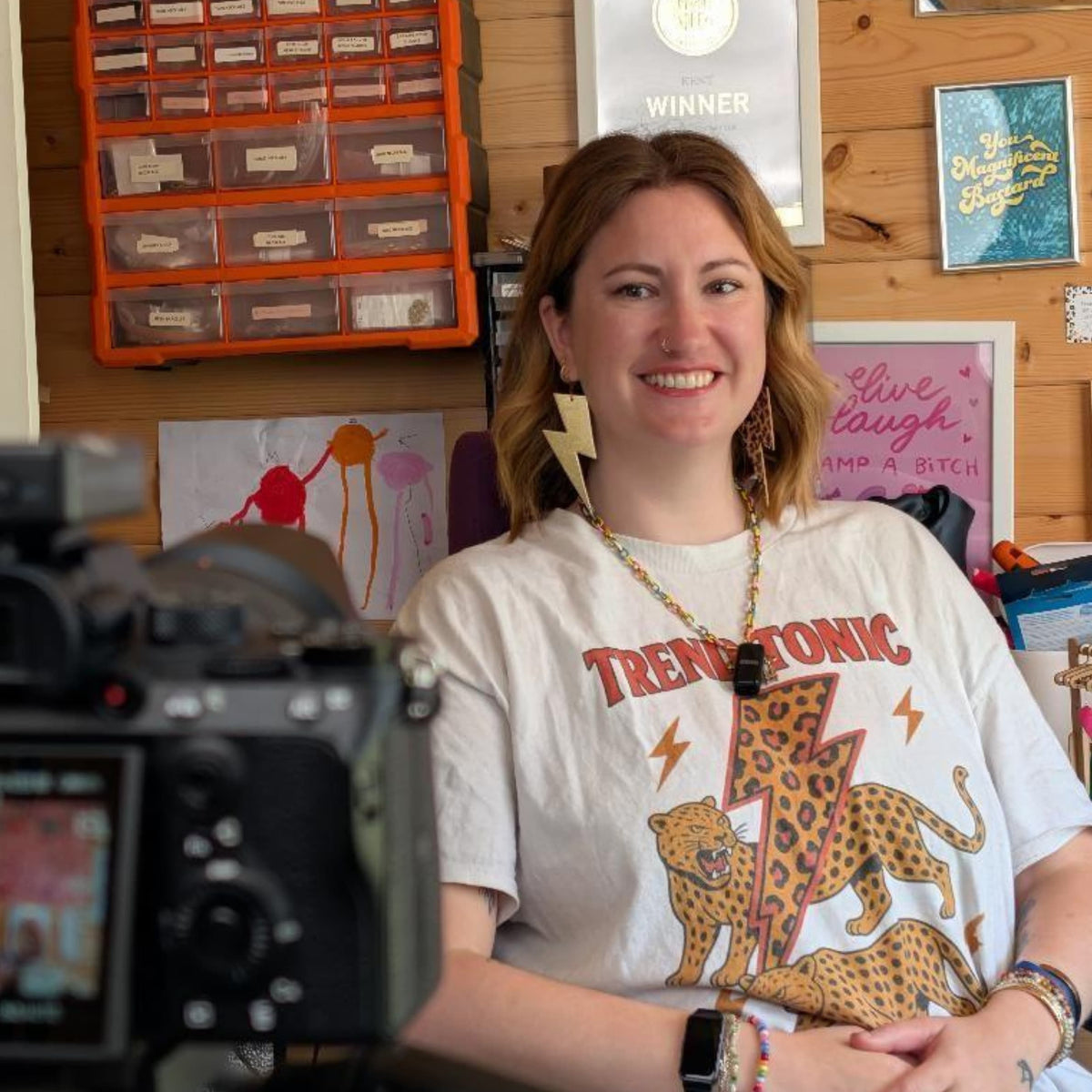 a woman sitting in front of a camera