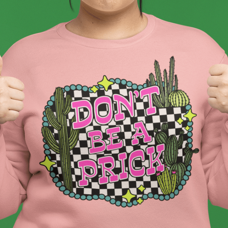 a person wearing a pink shirt with a cactus and a pink and black graphic
