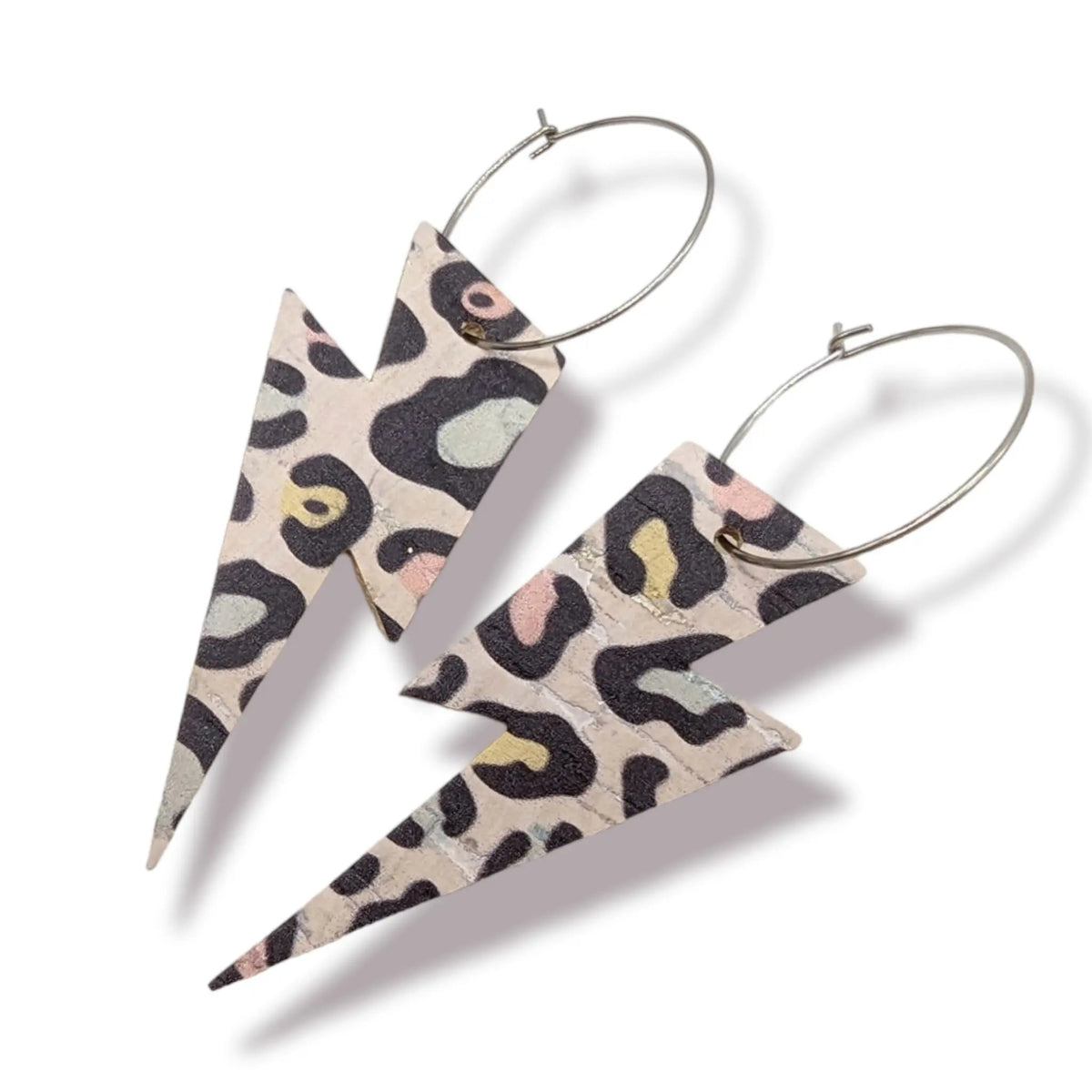 a pair of earrings with leopard print design
