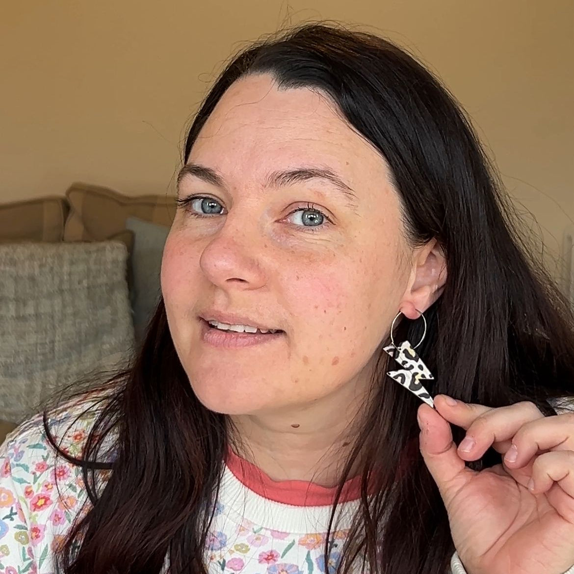 a woman with long hair wearing earrings