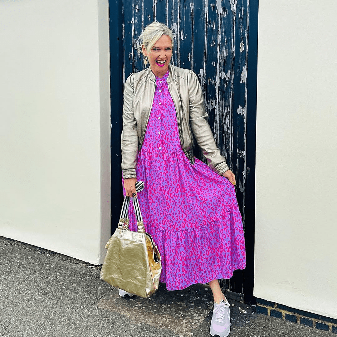 a woman in a pink dress and a silver jacket
