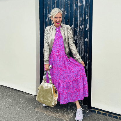 a woman in a pink dress and a silver jacket