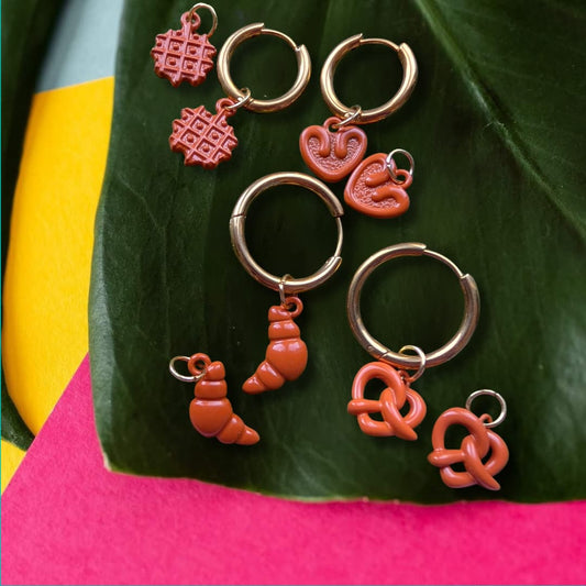 a group of earrings on a leaf