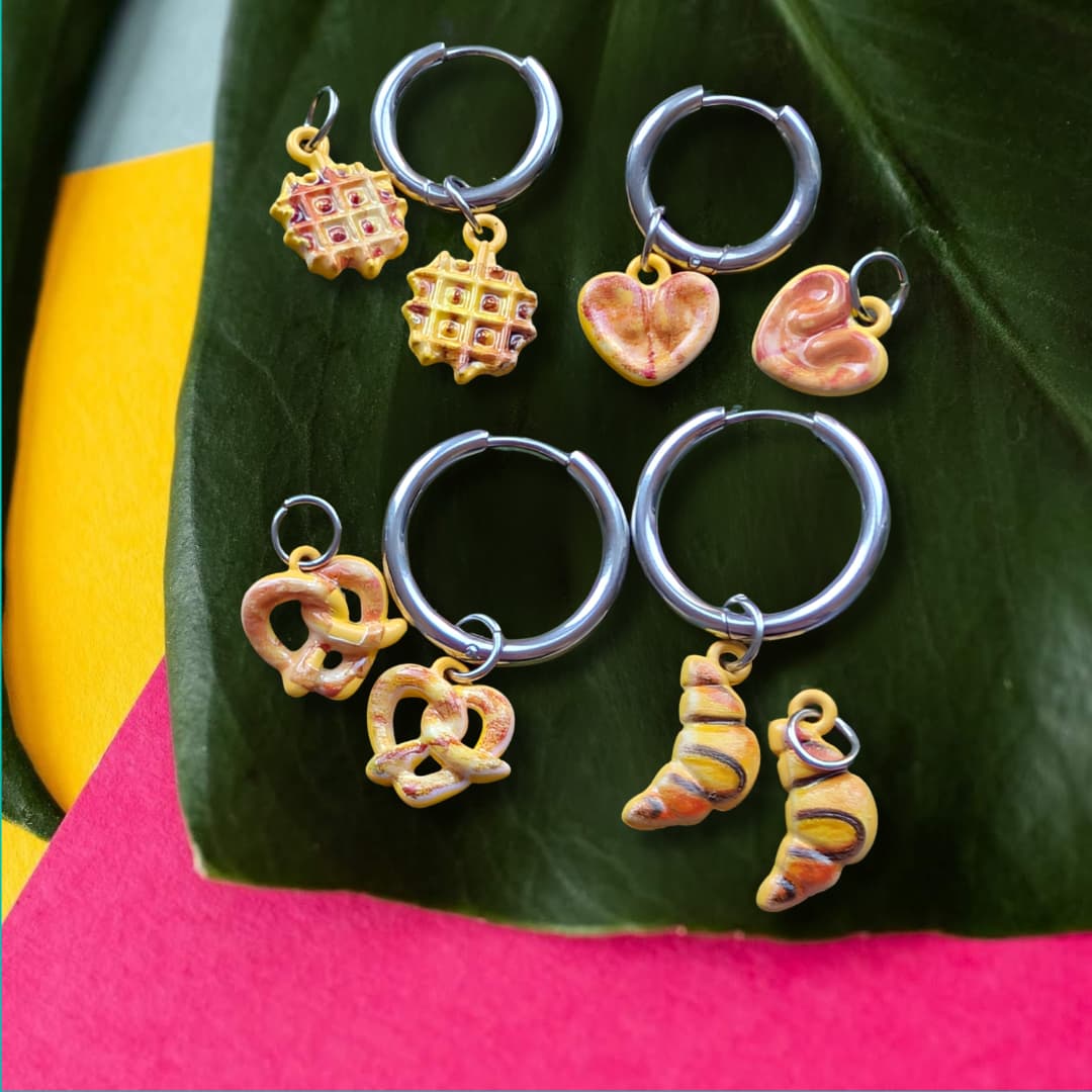 a group of earrings on a leaf