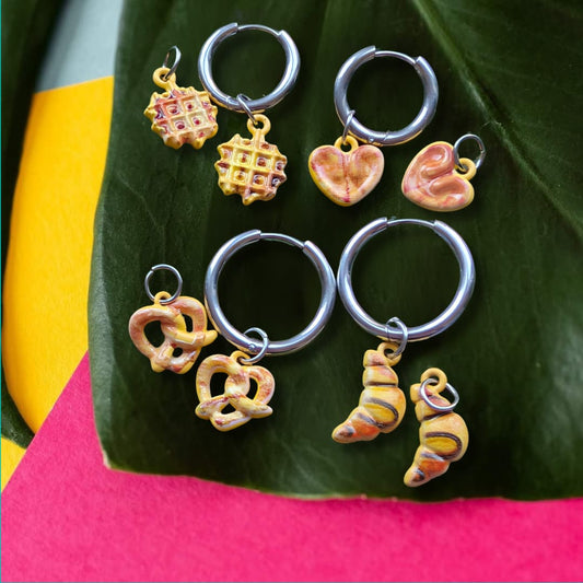 a group of earrings on a leaf