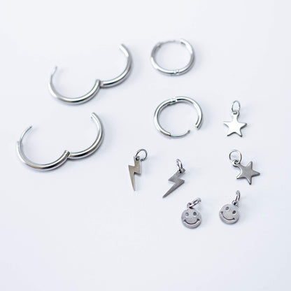 a group of silver earrings