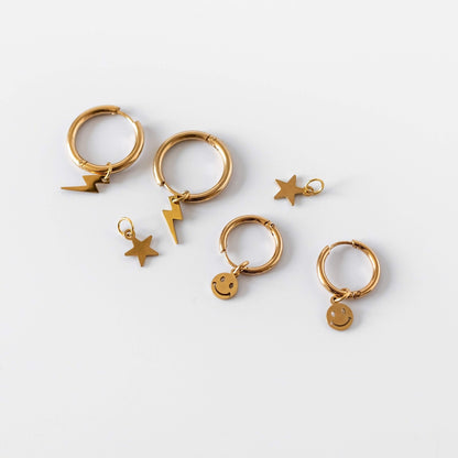 a group of gold earrings