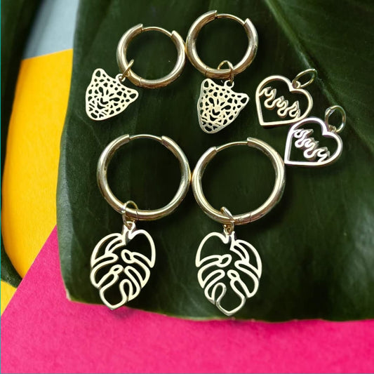 a group of earrings on a leaf