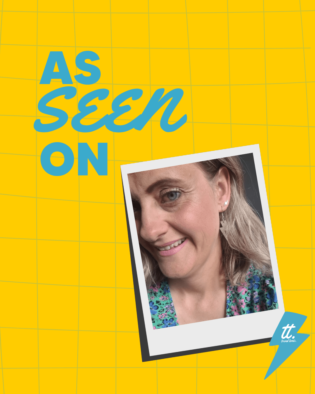 a woman smiling with a polaroid on a yellow background