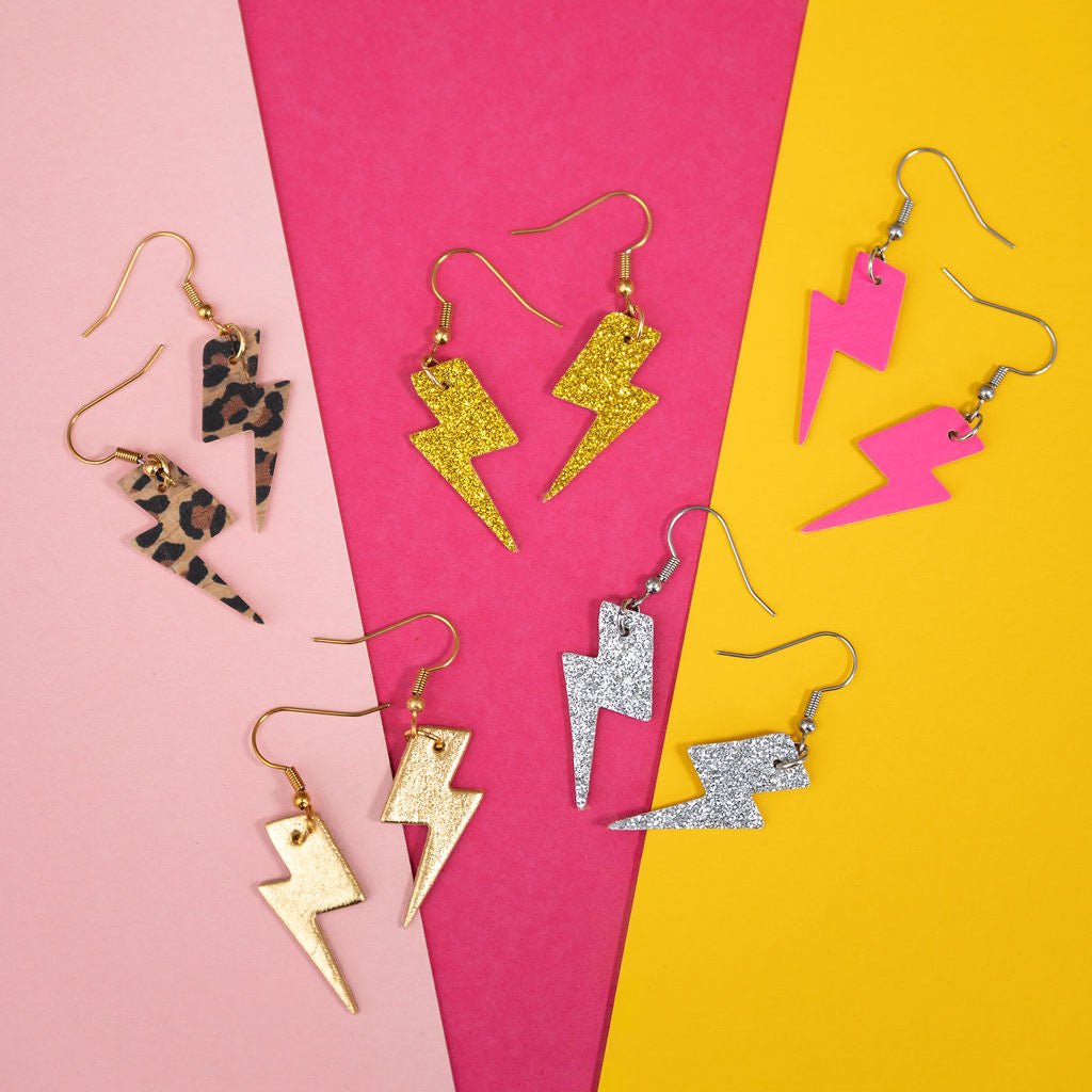 a group of earrings on a colorful surface