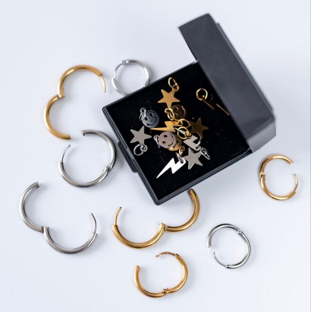 a box with gold and silver earrings