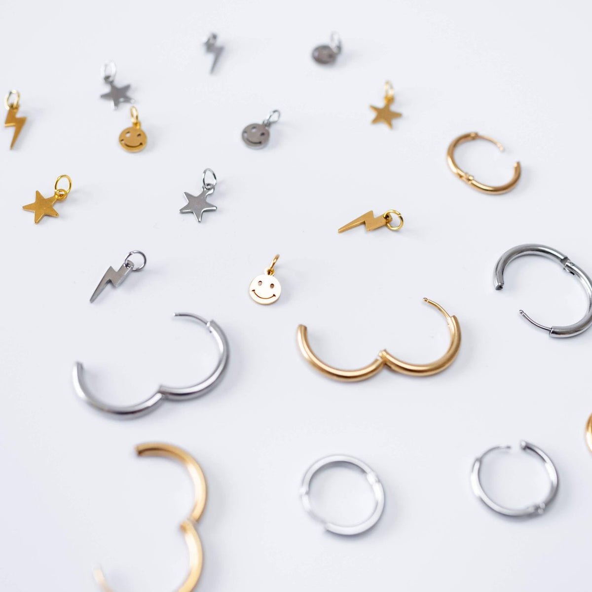 a group of earrings on a white surface