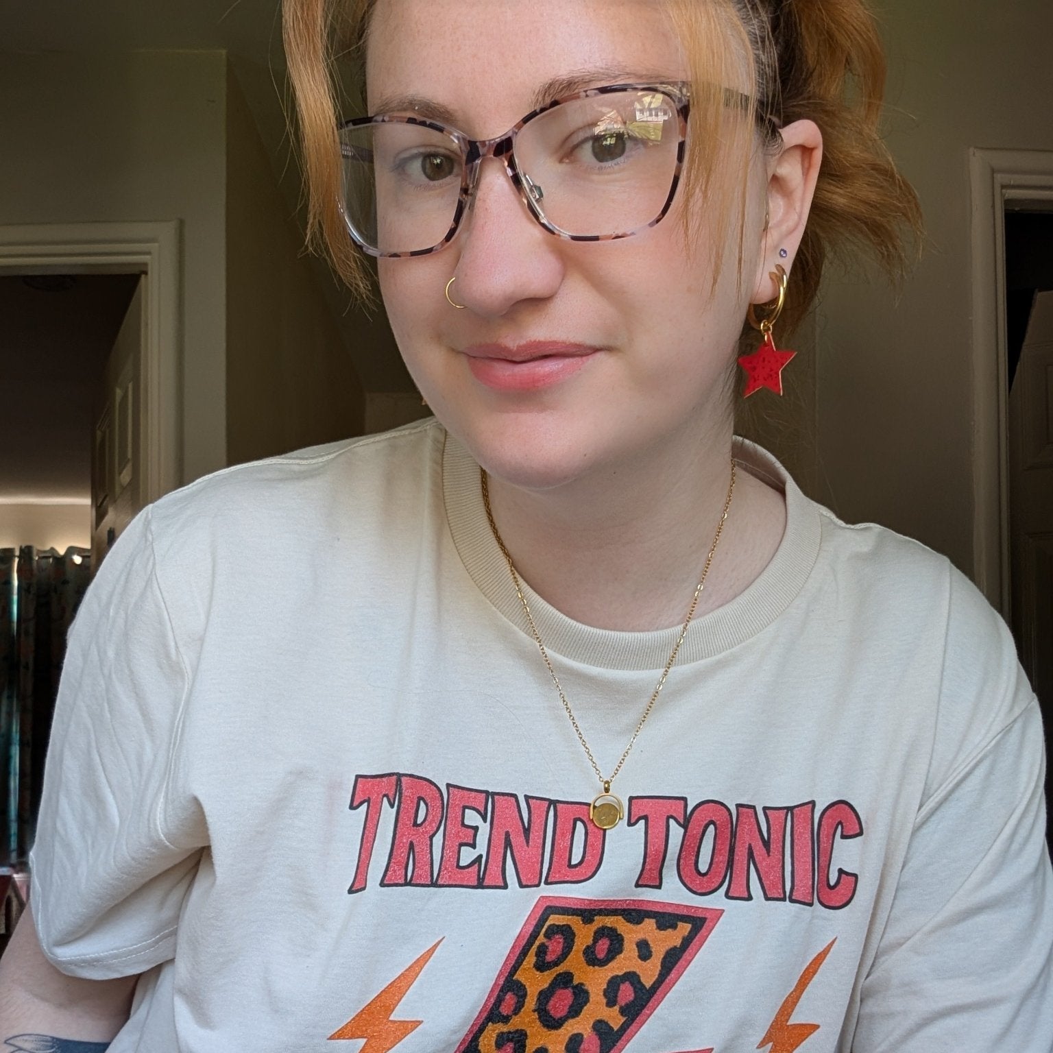 a woman wearing glasses and a white shirt
