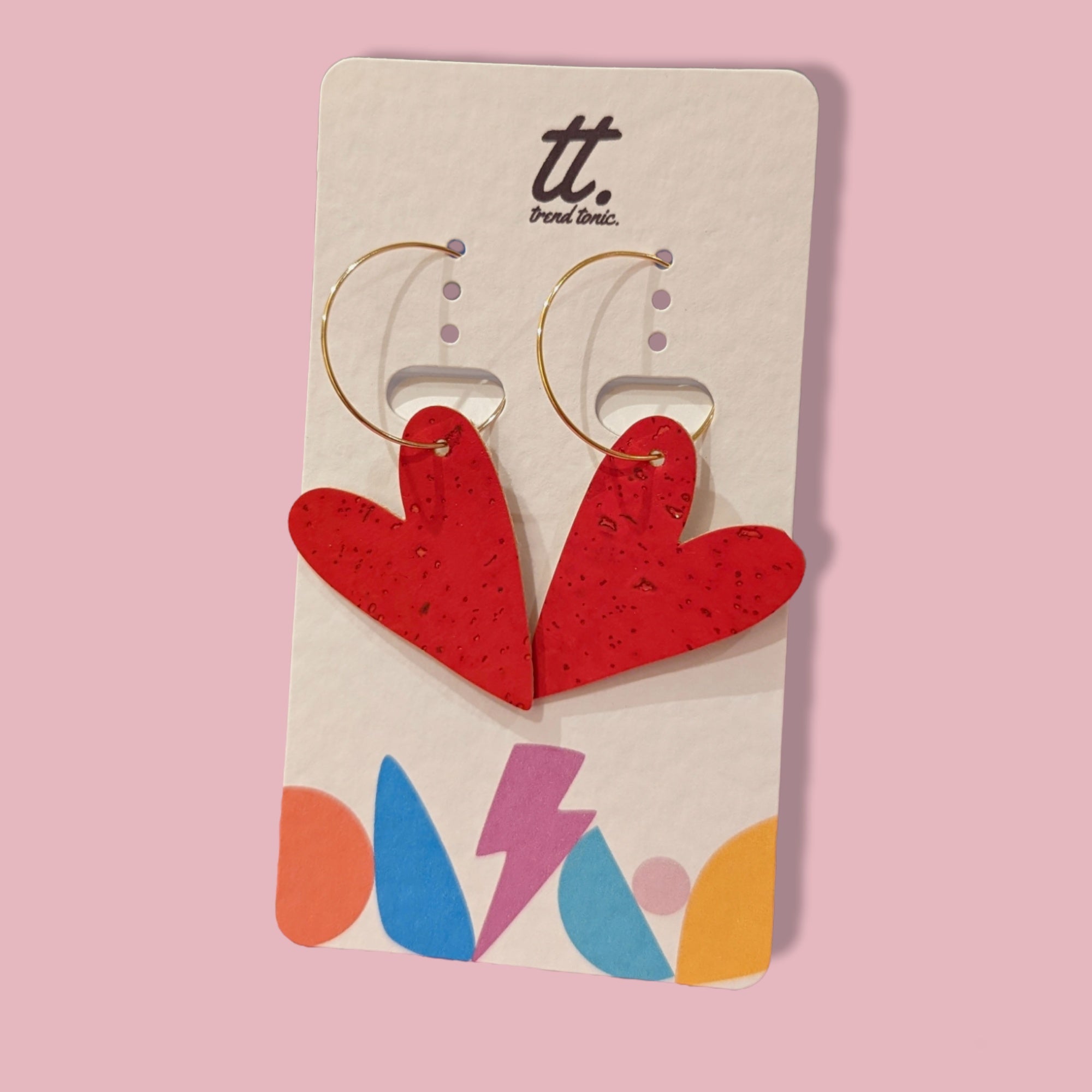 a pair of red heart shaped earrings