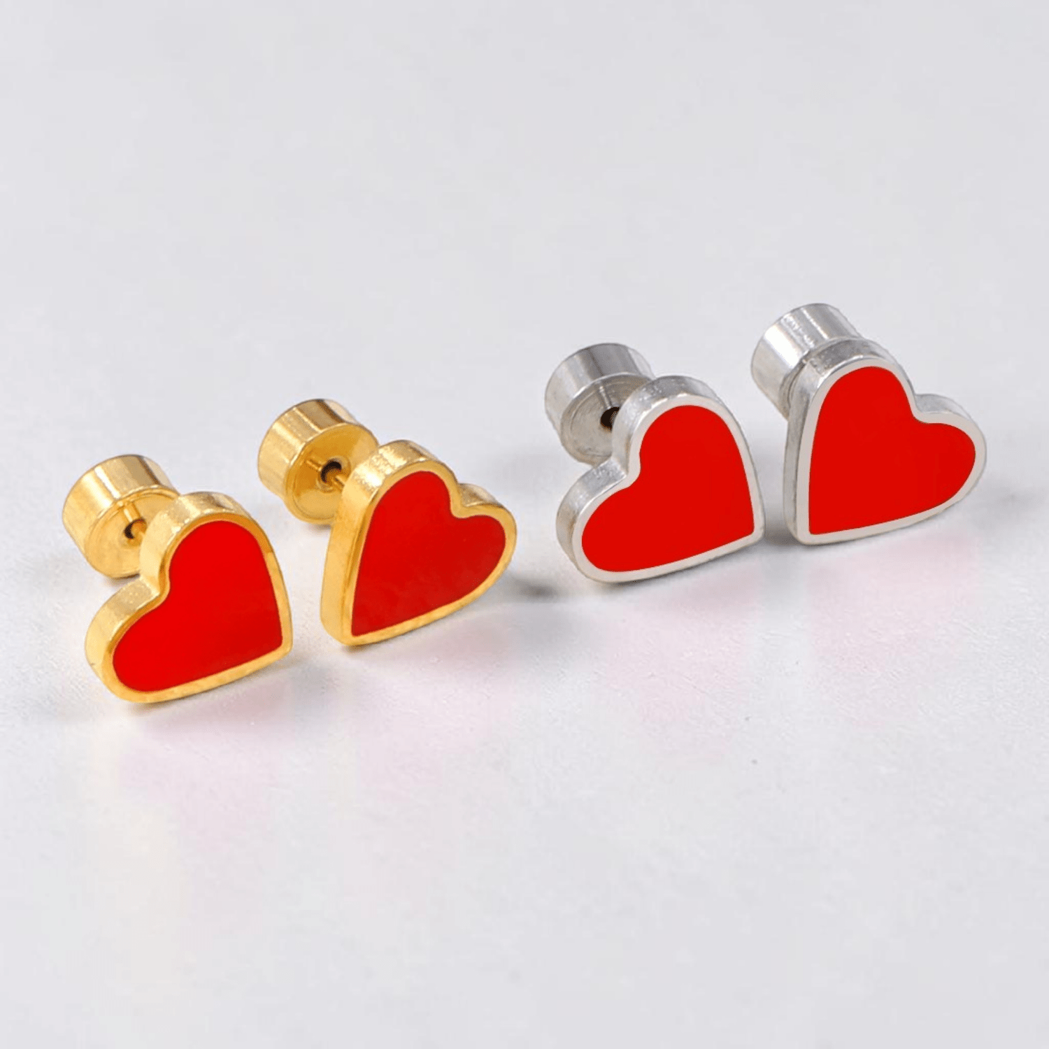 a pair of heart shaped earrings