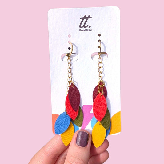a hand holding a pair of earrings