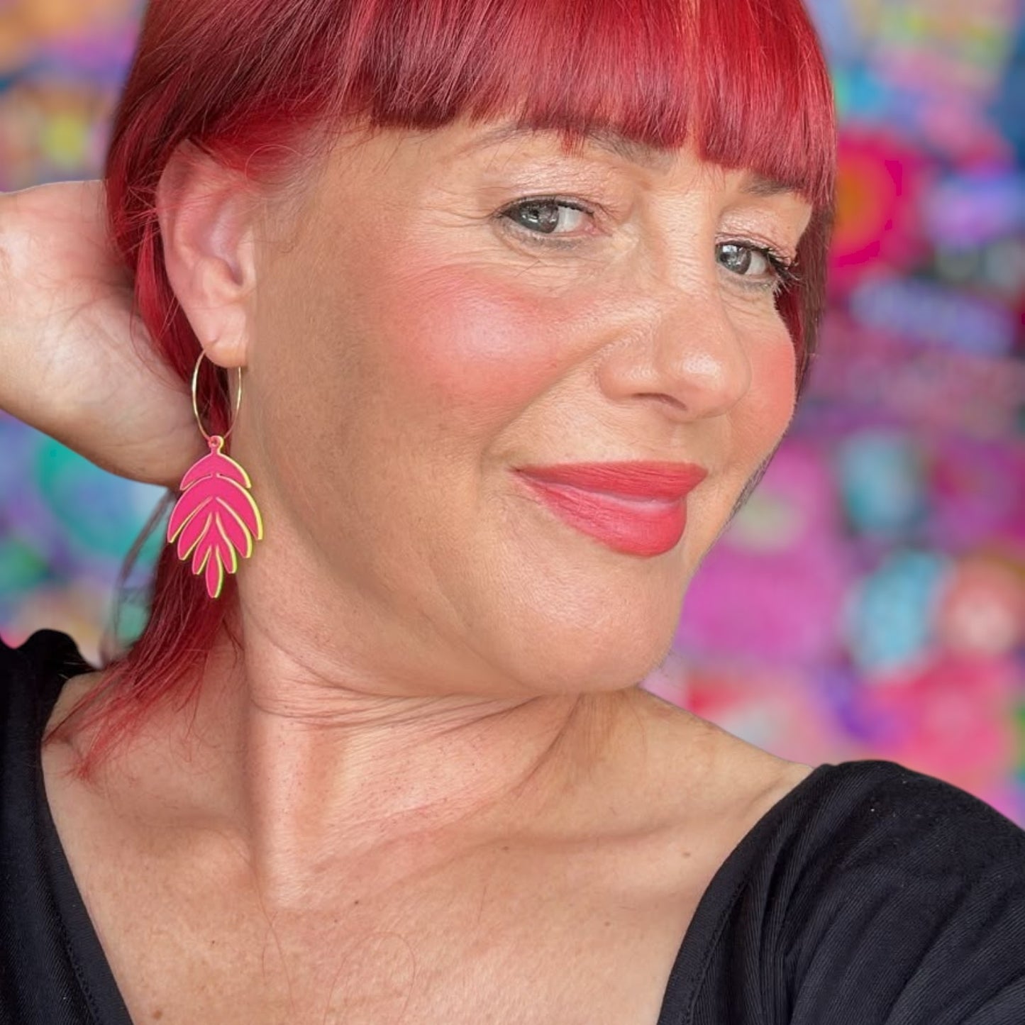 a woman with red hair and a black shirt