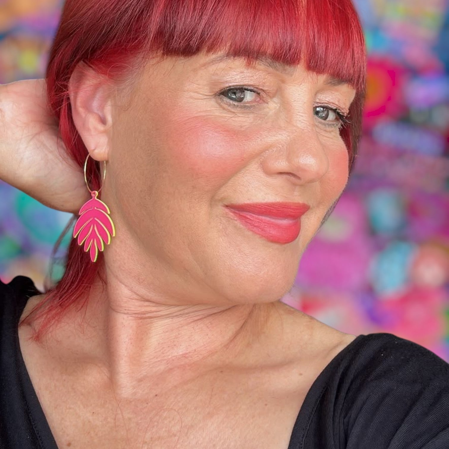 a woman with red hair and a black shirt