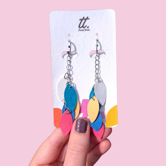 a hand holding a pair of earrings